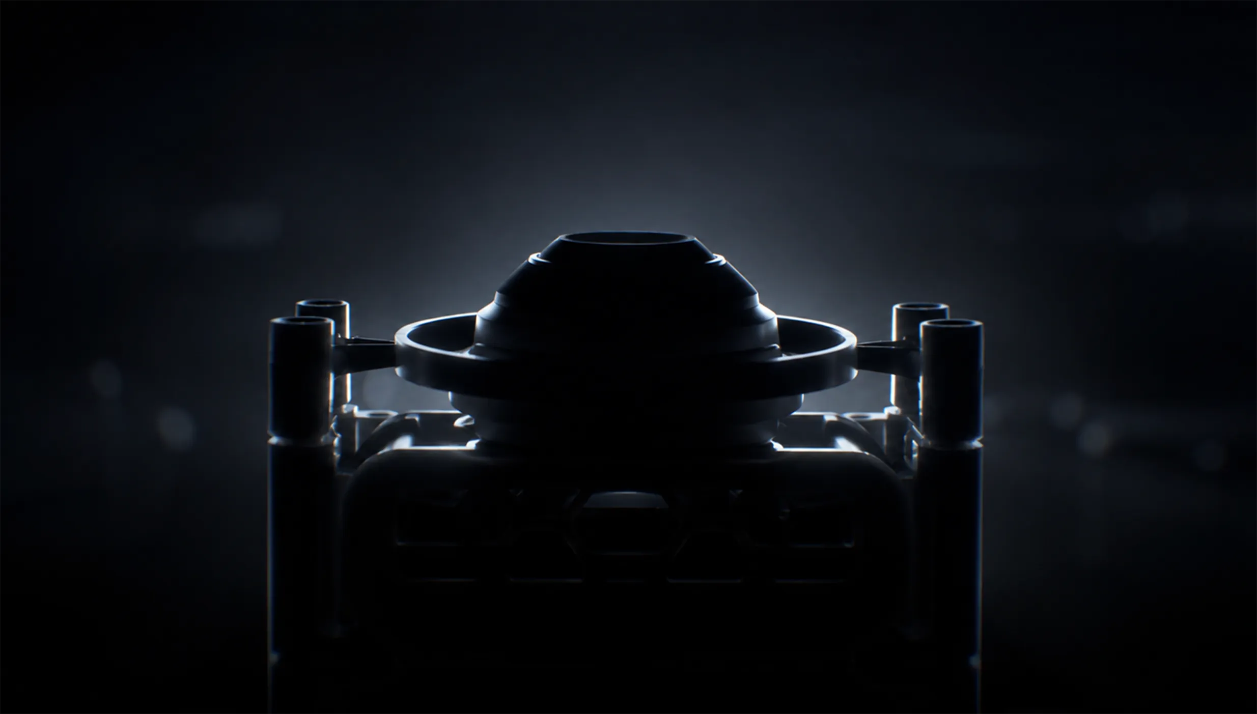 The XENSUR surgical training instrument, rim-lit in the dark